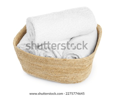 Wicker laundry basket with clean towels isolated on white
