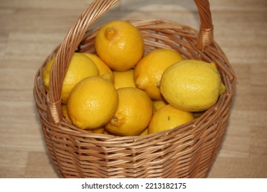 A Wicker Light Basket With Bright Yellow Lemons