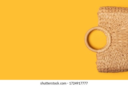 Wicker Straw Or Rattan Women's Eco Bag On Yellow Background. Flat Lay Top View. Concept Of Travel Summer Background With Copy Space. Beach Accessori