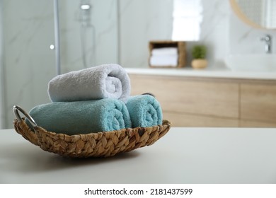 Wicker Tray With Clean Soft Towels In Bathroom. Space For Text