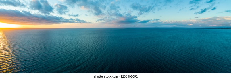 Wide aerial panorama of sunset over ocean - minimalistic seascape