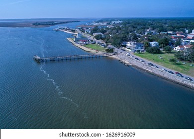 Wide Aerial View Of Downtown Southport NC. From Over The Water Looking Back At The Town And River Front. The Pier Is Also Visible.