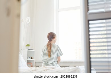 Wide Angle Back View At Lonely Child In Hospital Room, Shot From Doorway, Copy Space