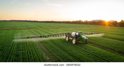Wide angle image of a crop spray machine spraying chemicals on wheat crop on a farm in south africa - Shutterstock ID 1850978332