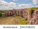 A Wide Angle Landscape of Dramatic Cloudy Summer Sky over a Blue Mounds State Park Cliffside Vista