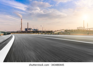 Wide Angle Landscape Photograph Of A Road Leading To A Power Plant