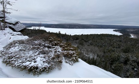 Wide Angle lookout view from Booths Rock in Algonquin Provincial Park, Ontario, Canada. The view over looks a frozen lake and forest in the Winter