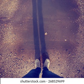  Wide Angle Overhead Shot Of Yellow And White Boat Or Deck Shoes In A Muddy Puddle With A Long Shadow Toned With A Retro Vintage Instagram Filter Effect App Or Action 