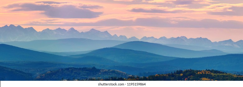 Wide angle panorama autumn forest,misty hills mountain tops in pink dawn - Powered by Shutterstock