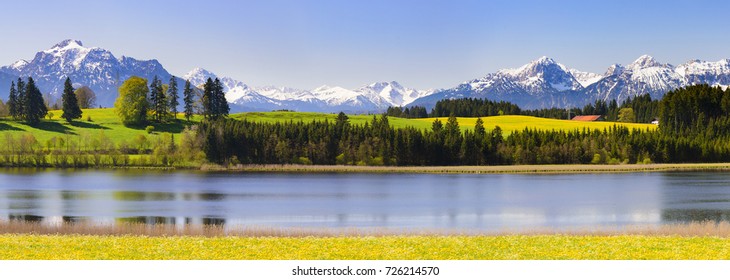 wide angle panorama landscape in Bavaria with lake and alps mountains