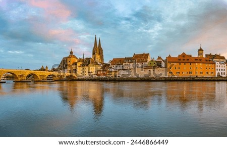 Wide angle panorama of Regensburg with old town and Stone Bridge on the Danube, picturesque sunset