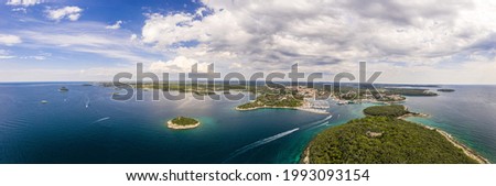 Wide angle panoramic drone picture over shore and islands along adriatic coast of Vrsar in summer