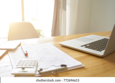 Wide Angle Perspective View Of Office Workplace With Laptop And Smart Phone On Wood Table With Window .