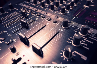 Wide angle photo of black sound mixer controller with knobs and sliders
