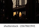 Wide angle photo during a sunset over New York, view from Dumbo area in Brooklyn with Empire States landmark building under Manhattan Bridge.