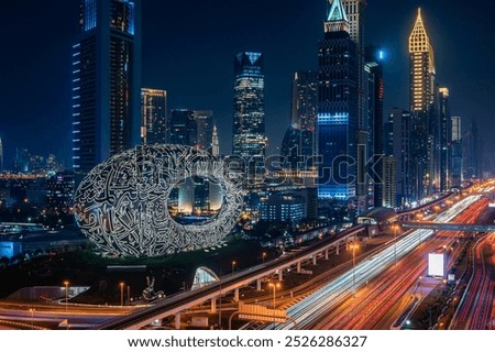 Wide angle photo of Museum of the future on Sheikh Zayed Road. Dubai at night. Tall high skyscrapers.

Translation: 