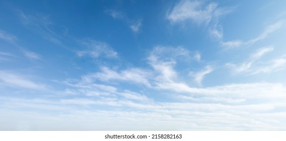 Wide angle photo of sunny and windy weather sky with blue tones. Summer or spring sky with cloudscape. - Shutterstock ID 2158282163