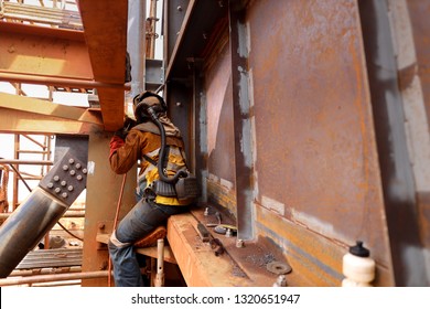 Wide Angle Pic Of Maintenance Welder Wearing Safety Red Glove Welding Helmet With Power Air Purifying Respirator While Performing Welding A Difficult Task Condition To Protect From The Toxic Fume  
