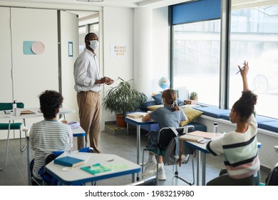 Wide Angle Portrait Of Male African-American Teacher Wearing Mask In School Classroom, Covid Safety Measures, Copy Space