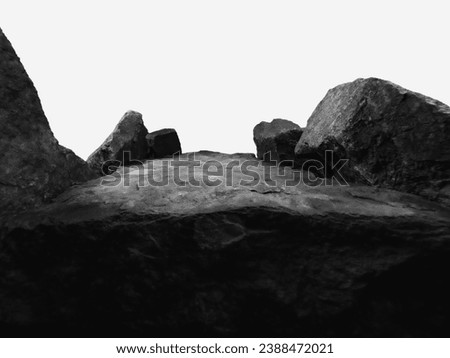 A Wide Angle of a Rock for a Product Display, Showing a Large Dark Blurred Foreground with intentional Focus to the Middle Top Surface of the Boulder with Close Natural Texture.