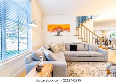 Wide Angle Shot of a Big Open luxurious and stylish bright living room. Spacious elegantly decorated big living space with fancy furniture and a Gray sectional couch. - Powered by Shutterstock