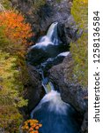 A Wide Angle Shot of the Cascade Waterfalls of Northern Minnesota under a Canopy of Fall Colors