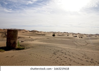 A wide angle shot of a desert under a sky full of clouds
