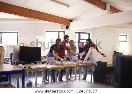 Wide Angle Shot Of Designers Brainstorming In Office Meeting