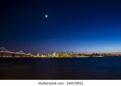 A Wide Angle Shot Of The San Francisco Skyline And Bay Bridge At Twilight.