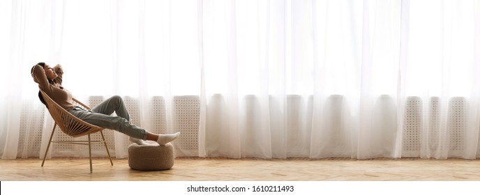 Wide Angle Shot Of Young Asian Girl Relaxing In Modern Wicker Chair Near Window, Enjoying Home Comfort, Extreme Long Banner, Panorama With Free Space - Shutterstock ID 1610211493