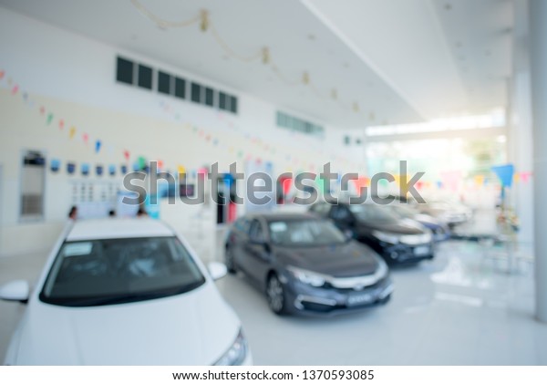 Wide angle in the showroom of car dealers\
New cars parked at stock, car dealers\
blurry.