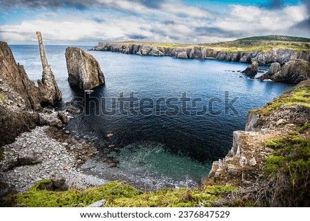 Wide angle Spillars Cove and Chimney Rock overlooking Cable John Cove and the Atlantic Ocean in Newfoundland and Labrador Canada.