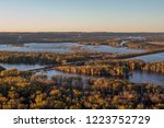 A Wide Angle Sunset Shot of a Freight Train Passing Through Wylausing State Park in Southern Wisconsin where the Wisconsin River flows into the Mississippi River during Autumn