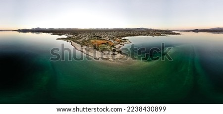 wide angle view from aerial view drone shot of lake mohave in the national recreation area of lake mead in nevada and arizona with the sun setting showing six mile cove and its sand