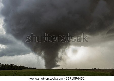 Wide Angle View of Big EF-3 Tornado Spinning Through Field 