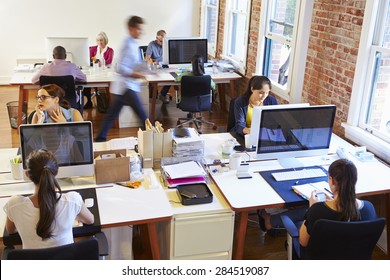 Wide Angle View Of Busy Design Office With Workers At Desks - Powered by Shutterstock