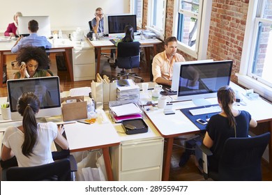 Wide Angle View Of Busy Design Office With Workers At Desks