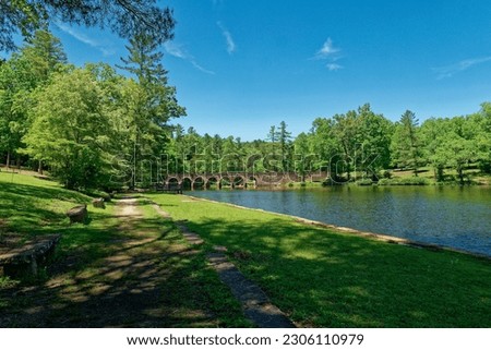 Wide angle view of Byrd lake with the seven arched stone bridge in the background on a bright sunny day in springtime at the Cumberland mountain state park in Tennessee Stock photo © 