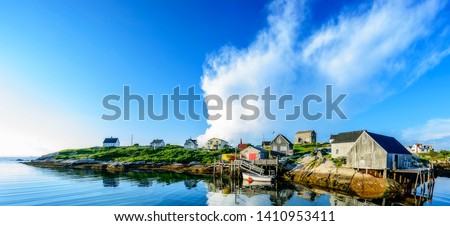 A wide angle view of a  calm summer evening in the fishing village of Peggys Cove, Nova Scotia. 
