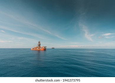 Wide Angle View Of Deep Water Drill Ship Carrying Out Drilling At Oil Field.