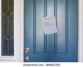 Wide Angle View Of An Eviction Notice On The Door Of Home, Focus Of Sign