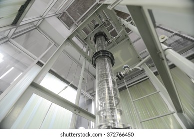 Wide Angle View Of Extraction Column In Laboratory With Ladder And Metal Plating Around It