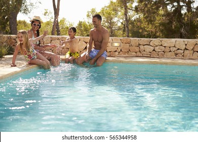 Wide Angle View Of Family On Vacation Having Fun By Pool