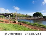 Wide angle view of the famous wooden suspension swinging bridge to cross the river in Hanapepe Kauai