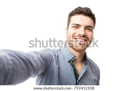 Similar – Image, Stock Photo Smiling latin man taking a selfie in front of multicolored glass panels.
