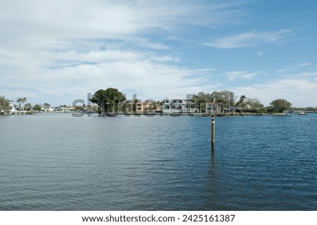 Wide angle view looking east over Coffee Pot Bay in Saint Petersburg, FL. Sunny day with blue sky with white clouds and calm water. With green trees in right foreground. one post in lower right side.
 Stok fotoğraf © 