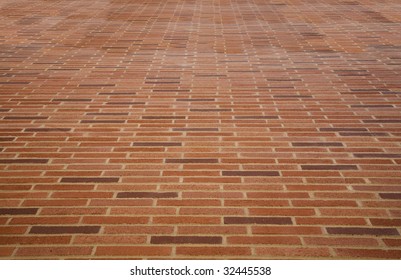 Wide angle view looking up an impossibly high brick wall.