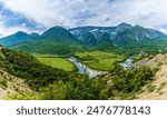 A wide angle view over the Vjosa river valley and the Nemercka mountain chain in Albania in summertime