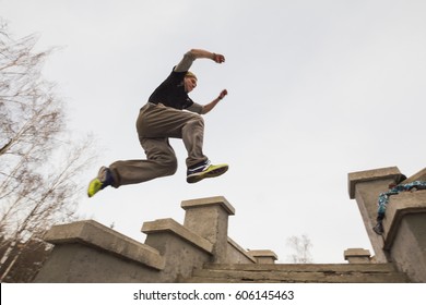 Wide angle view - parkour jumping in winter snow park - free-run training - Powered by Shutterstock