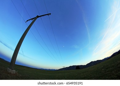 Wide angle view of a power pole at night